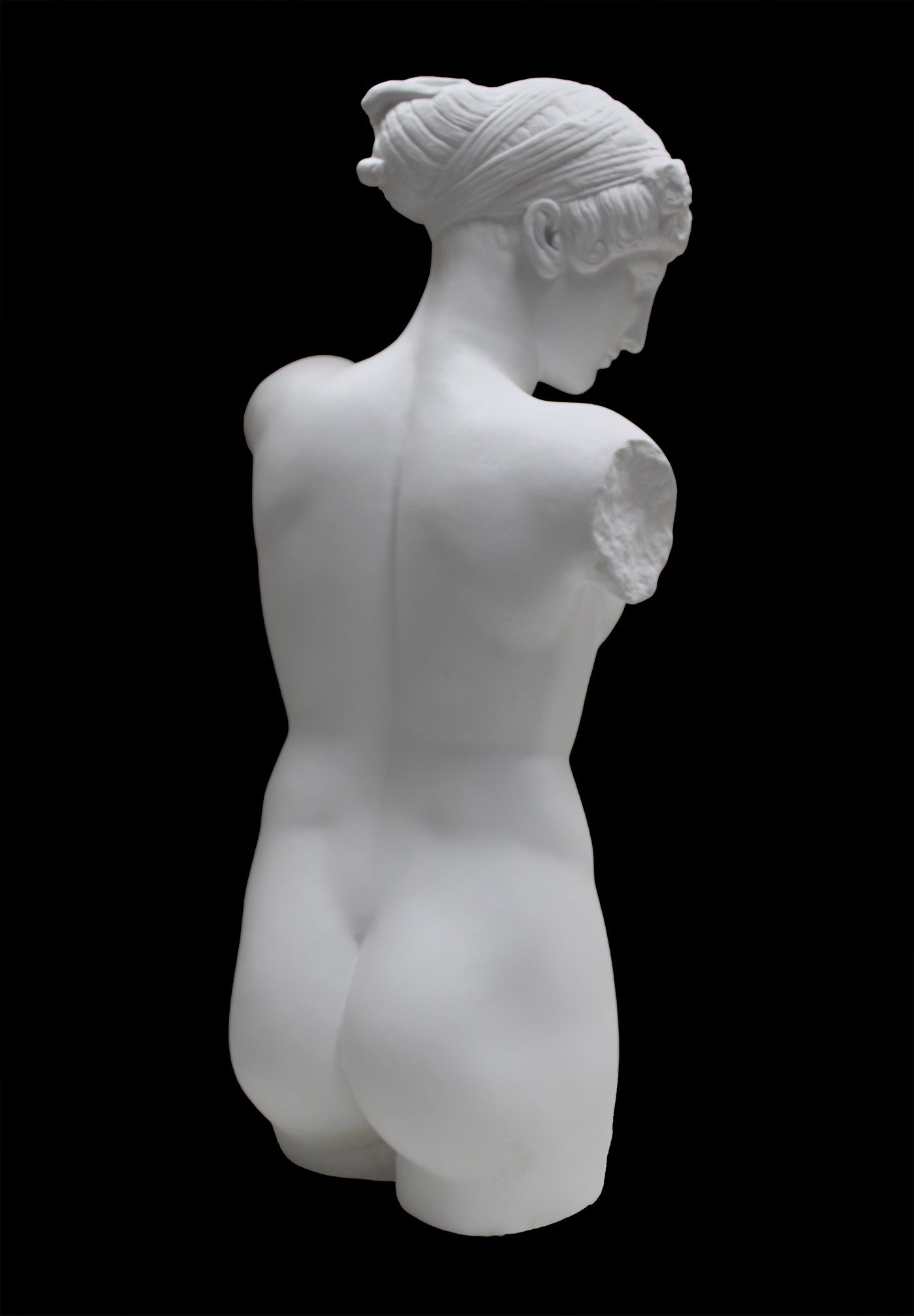Photo of a sculpture of a female torso with a head