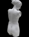 Photo of a sculpture of a female torso with a head