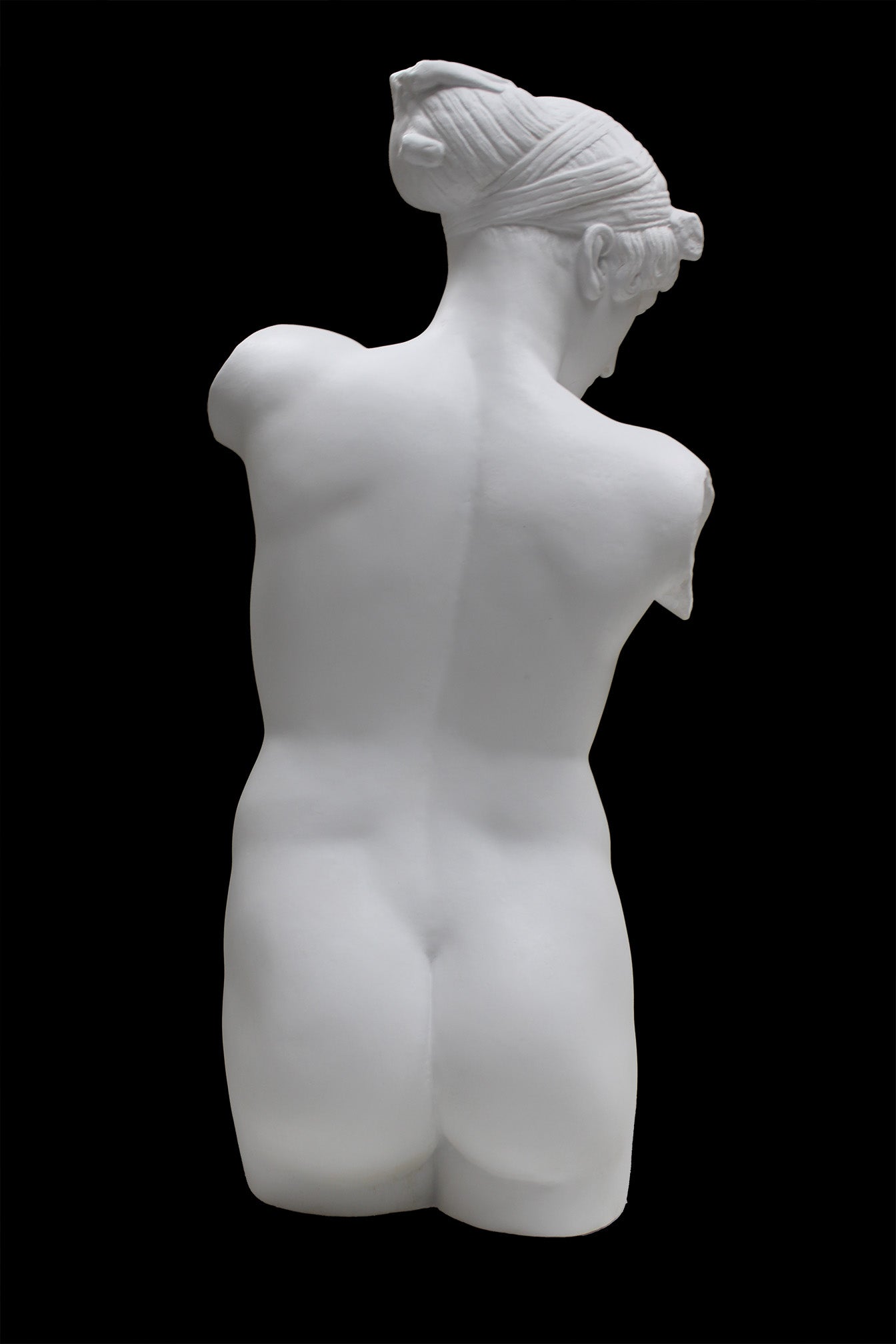 Photo of a sculpture of a female torso with a head