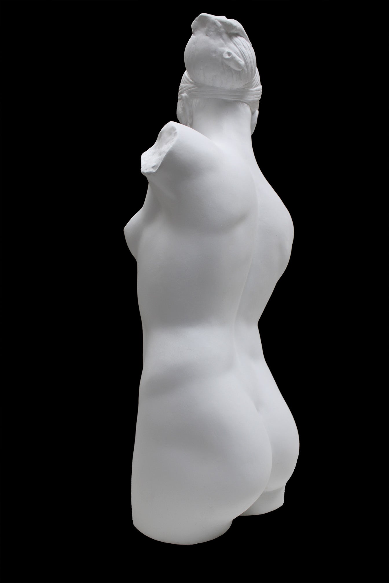 Photo of a sculpture of a female torso with a head