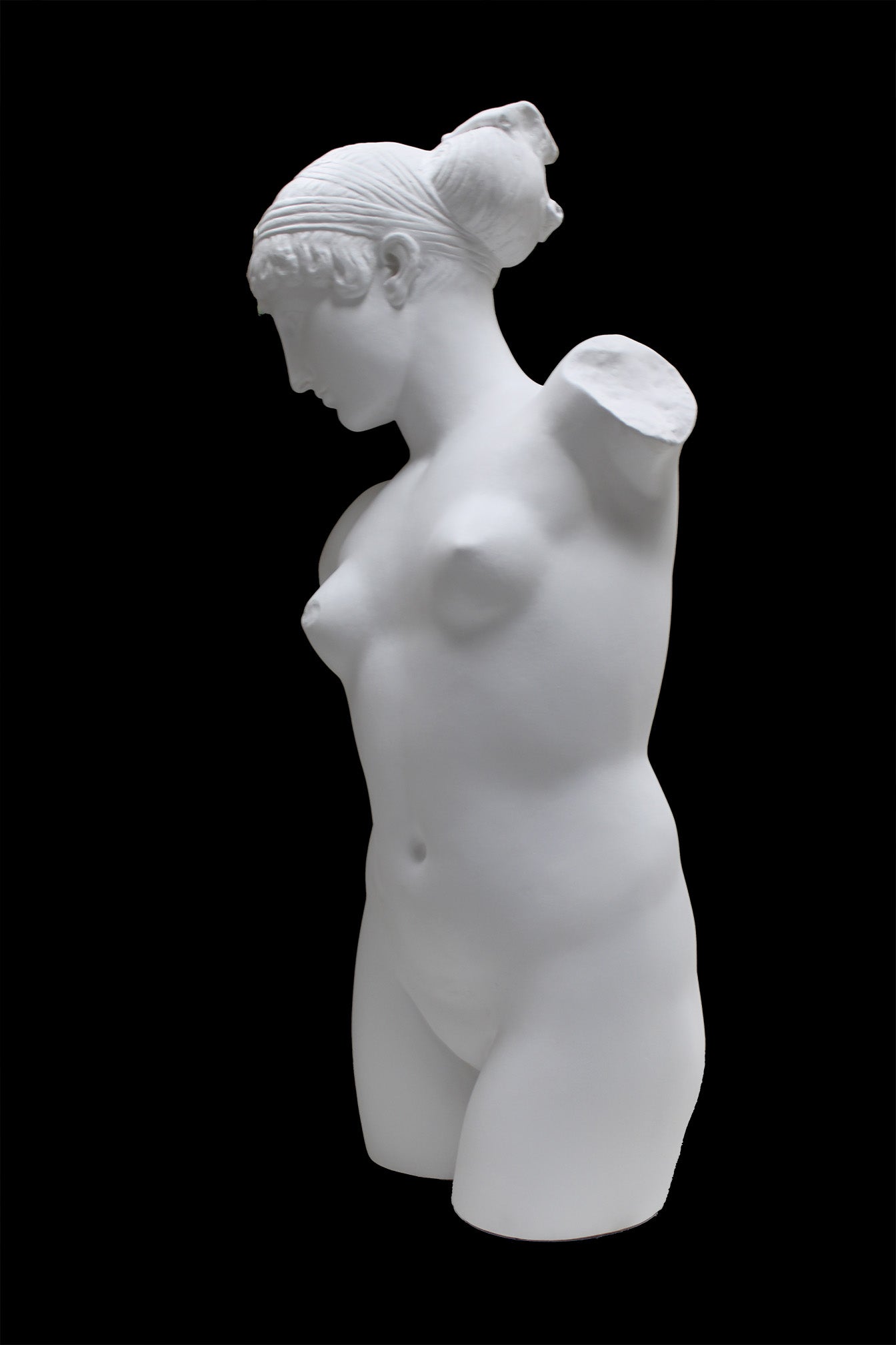 Photo of a sculpture of a female torso with a head