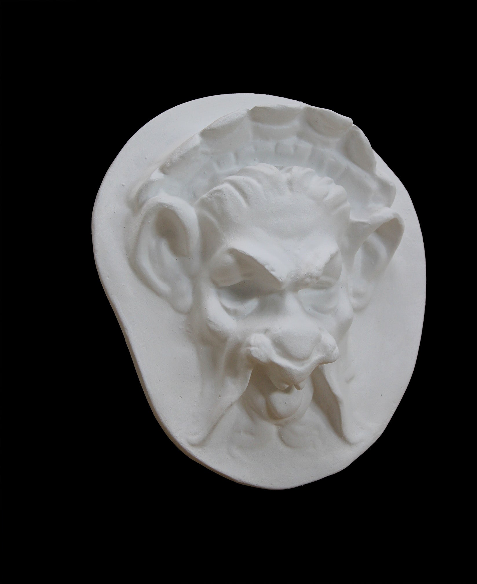 Photo of  a sculpture of a faun on a black background