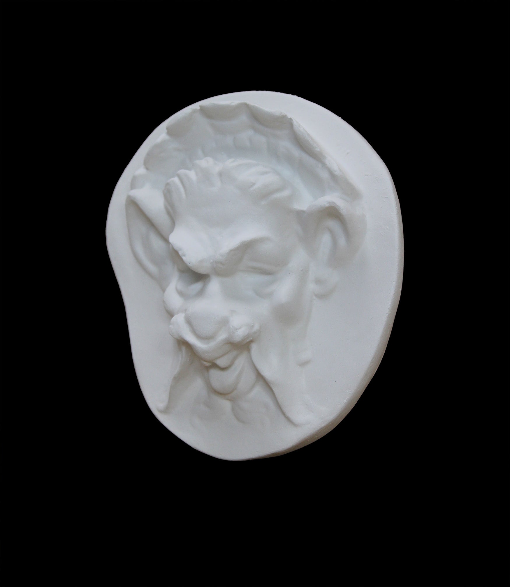 Photo of  a sculpture of a faun on a black background