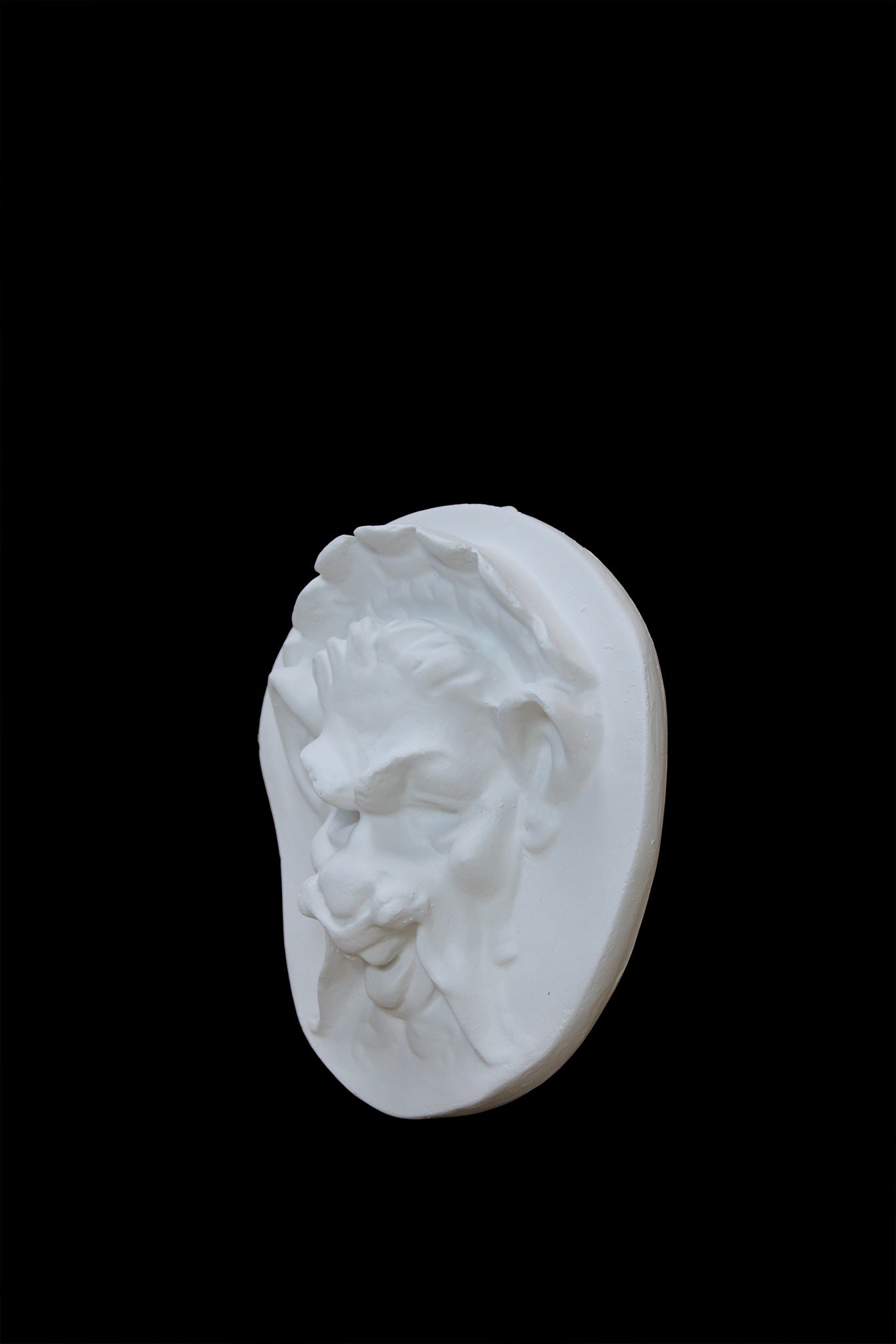Photo of  a sculpture of a faun on a black background