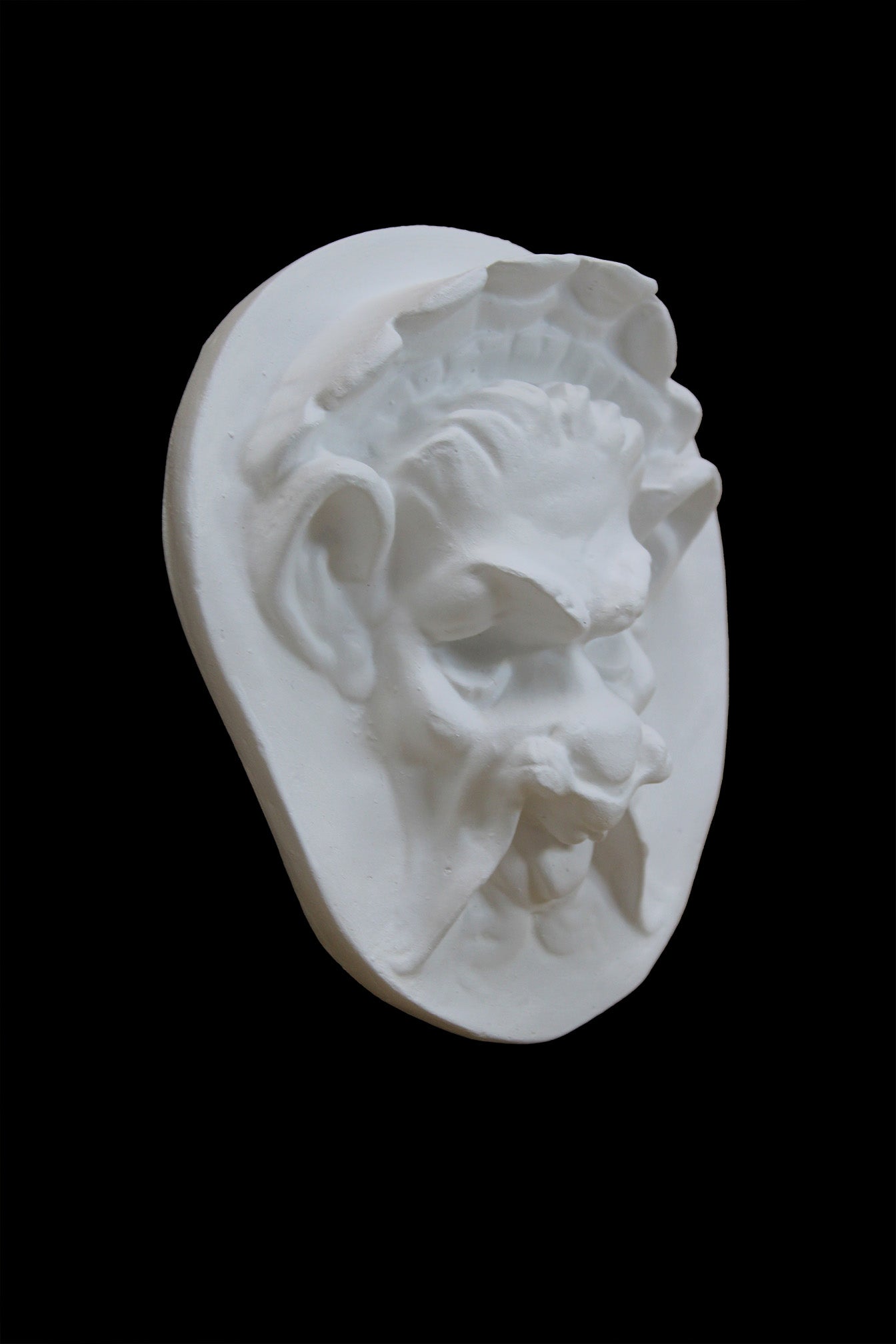 Photo of  a sculpture of a faun on a black background