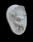Photo of  a sculpture of a faun on a black background