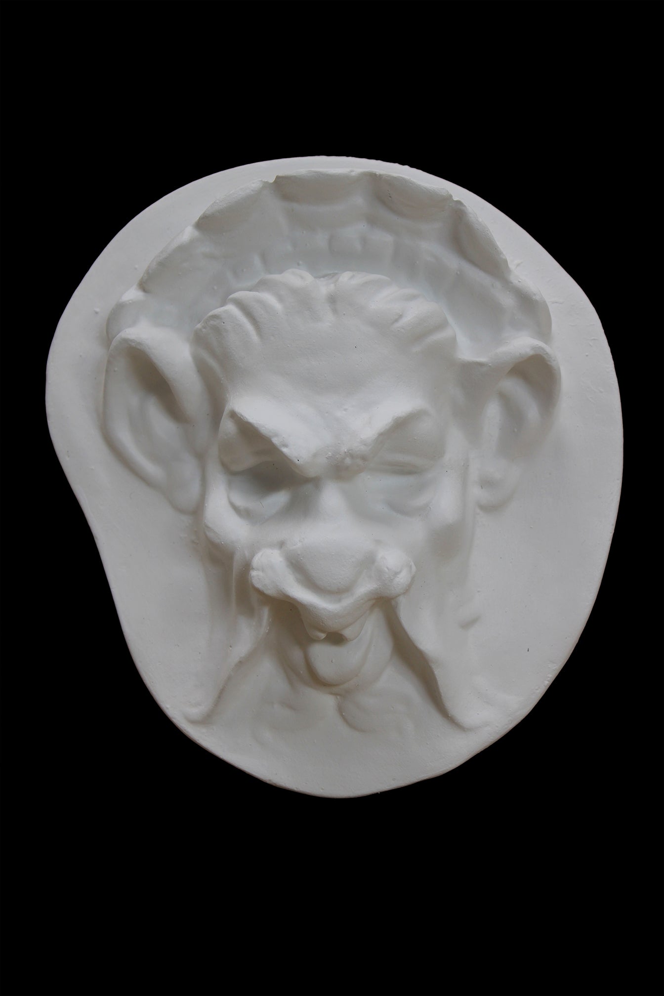 Photo of  a sculpture of a faun on a black background
