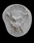 Photo of  a sculpture of a faun on a black background