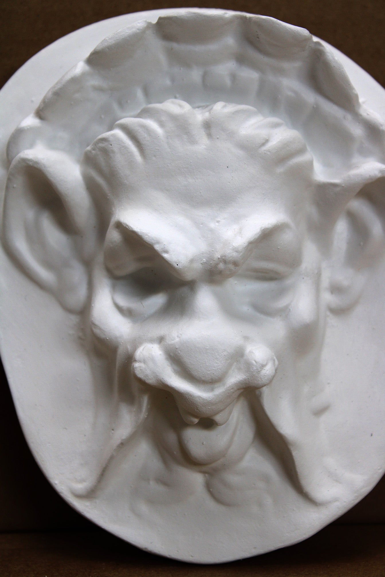 Photo of  a sculpture of a faun on a black background