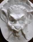 Photo of  a sculpture of a faun on a black background