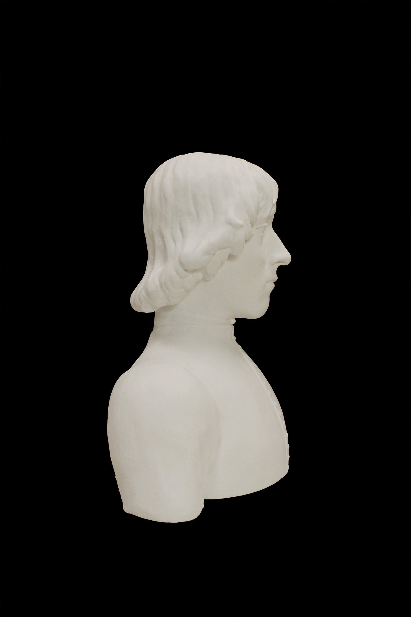 photo of plaster cast bust of man with high-neck shirt and shoulder-length hair with black background