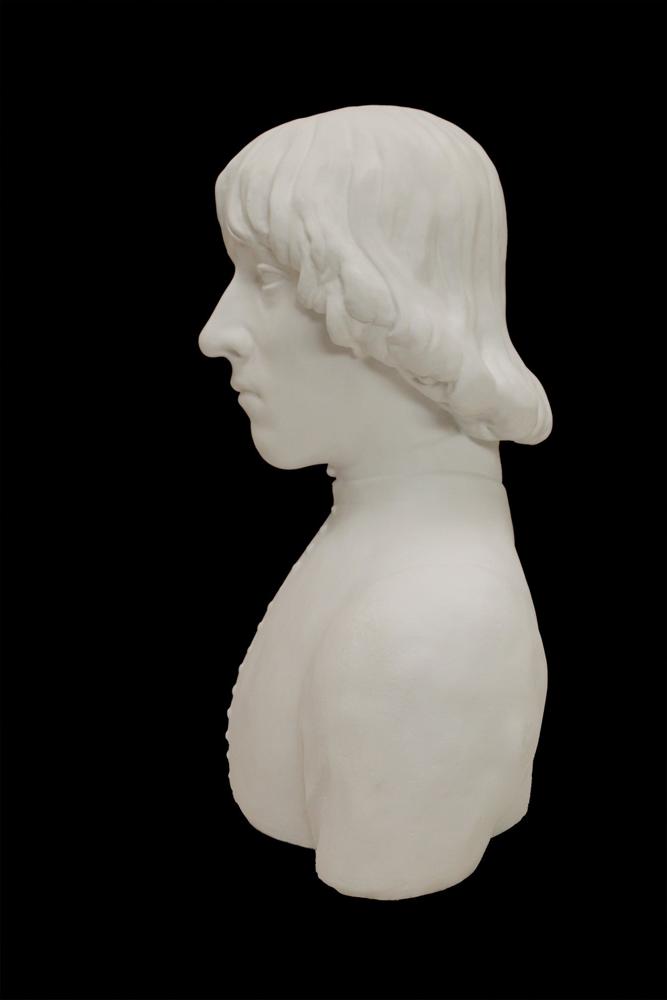 photo of plaster cast bust of man with high-neck shirt and shoulder-length hair with black background