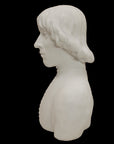 photo of plaster cast bust of man with high-neck shirt and shoulder-length hair with black background