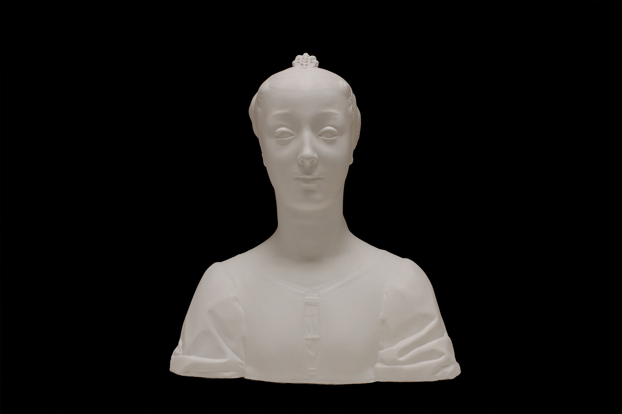 photo of white plaster cast of female bust with up-do and dress against black background