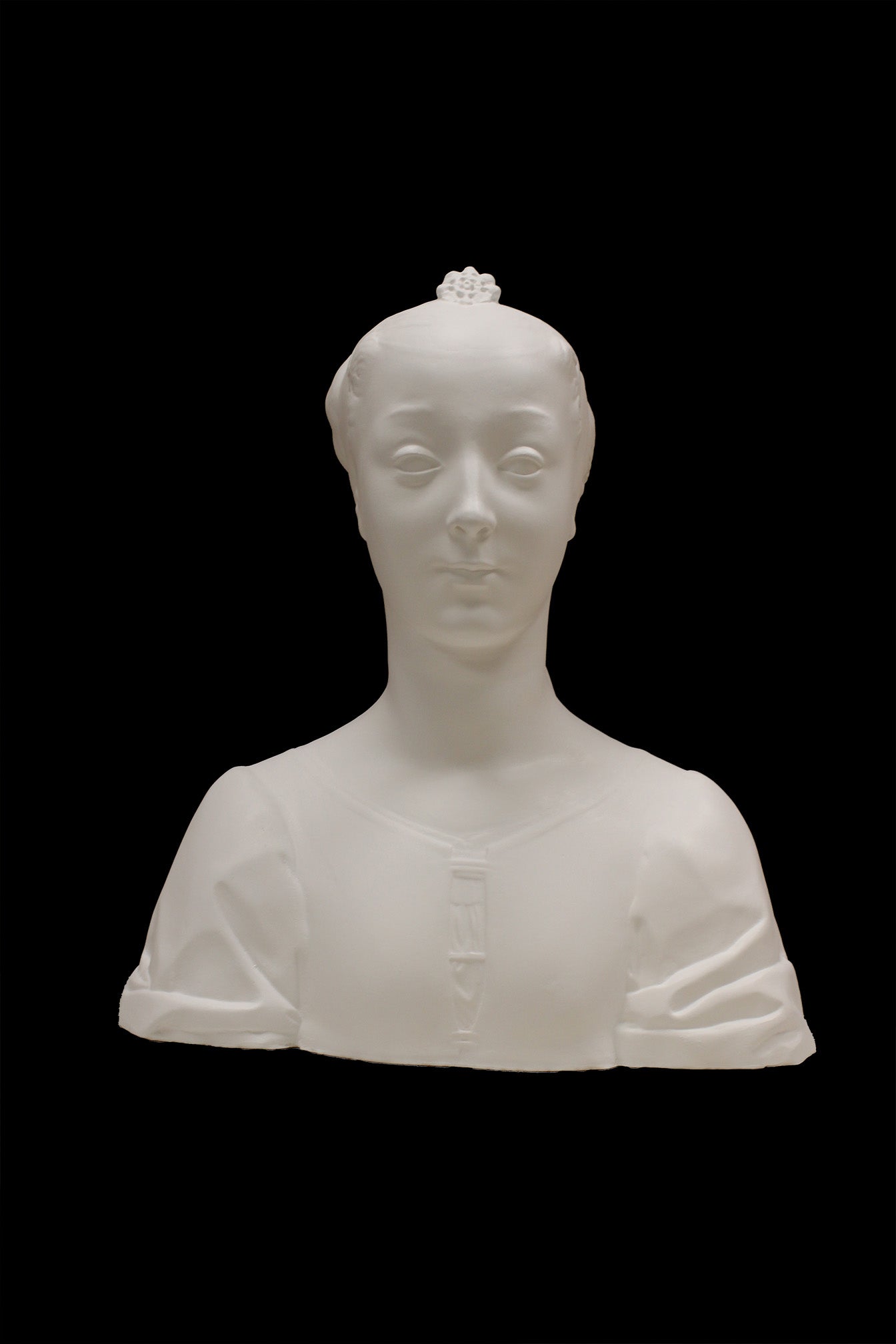 photo of white plaster cast of female bust with up-do and dress against black background