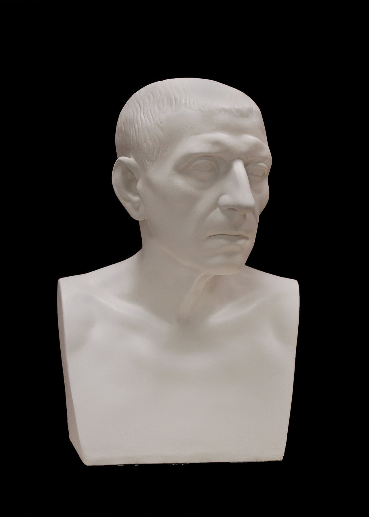 image of a plaster statue of a bust of cicero on a black background