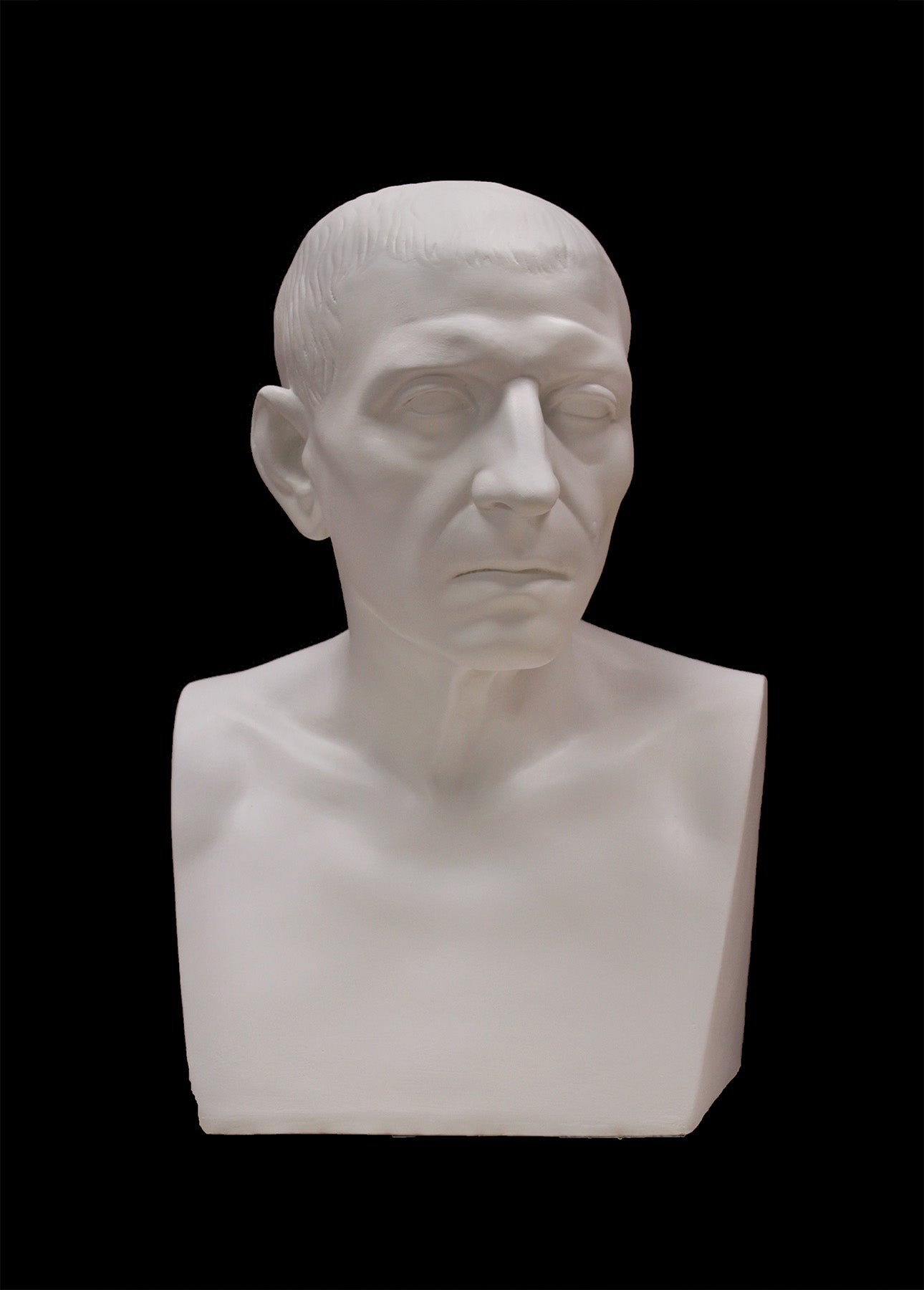 image of a plaster statue of a bust of cicero on a black background