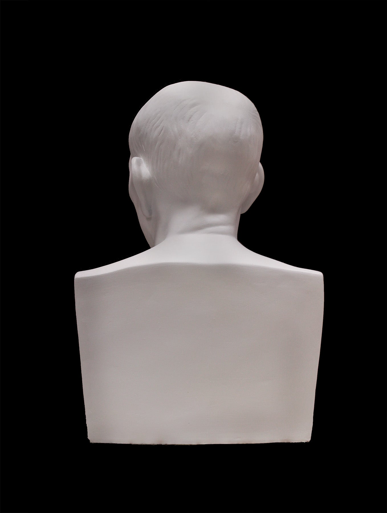 image of a plaster statue of a bust of cicero on a black background