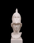 photo of plaster cast sculpture bust of female head, namely the goddess Athena, with a helmet on a black background