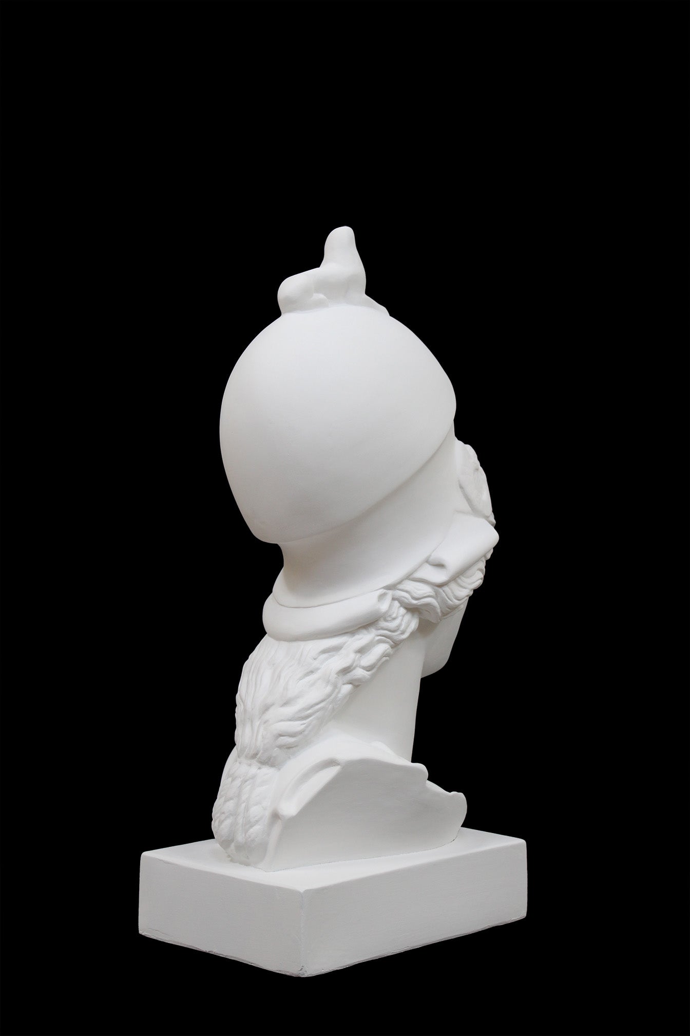 photo of plaster cast sculpture bust of female head, namely the goddess Athena, with a helmet on a black background