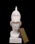 photo of plaster cast sculpture bust of female head, namely the goddess Athena, with a helmet on a black background