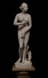 photo of plaster cast sculpture of Venus standing nude with two putti riding a dolphin at her feet on black background
