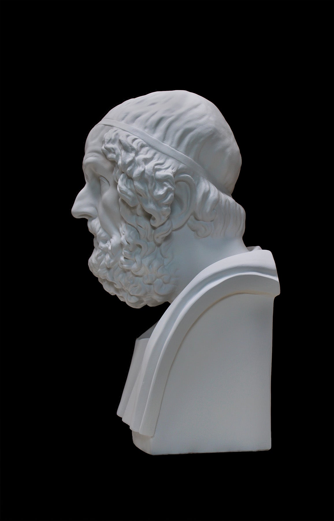 image of a plaster statue of a bust of homer on a black background