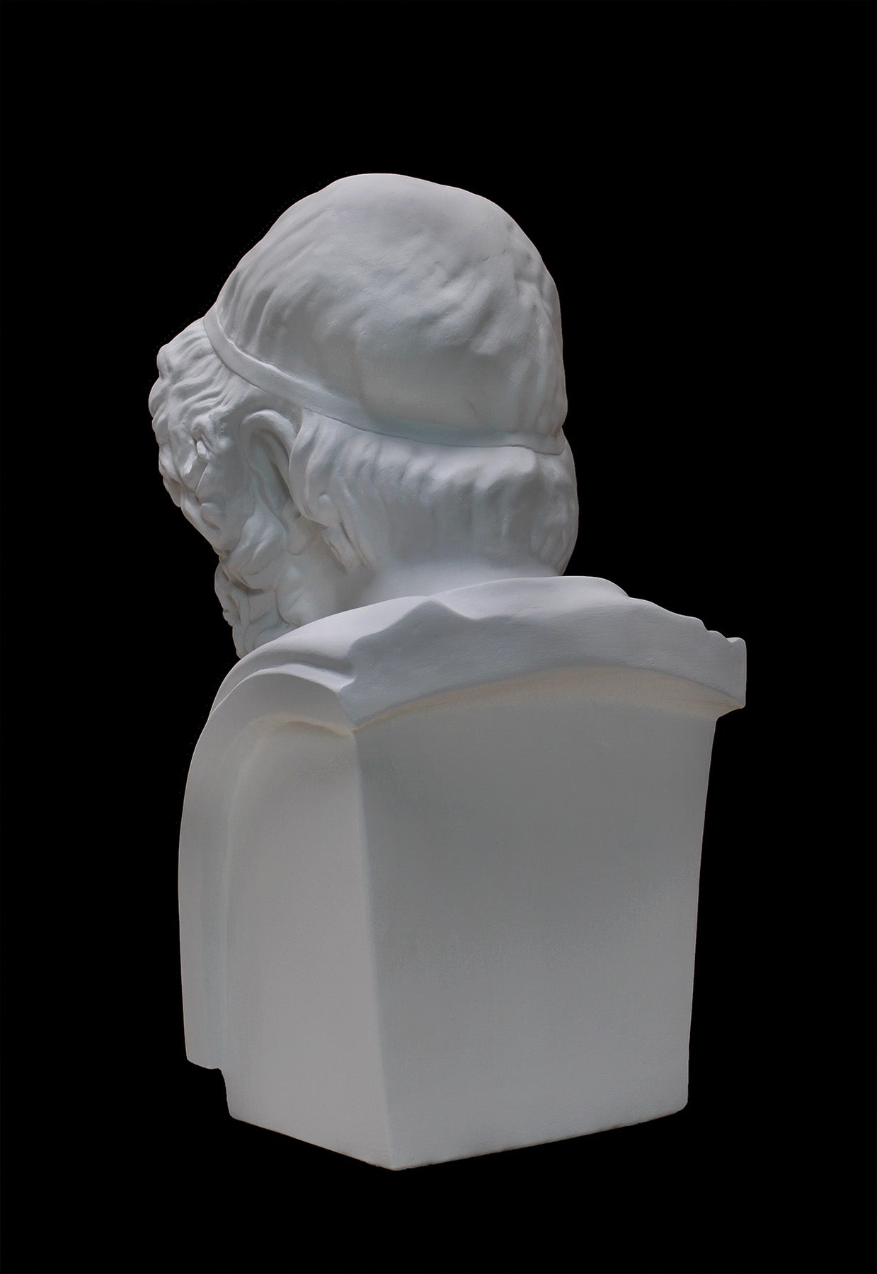 image of a plaster statue of a bust of homer on a black background