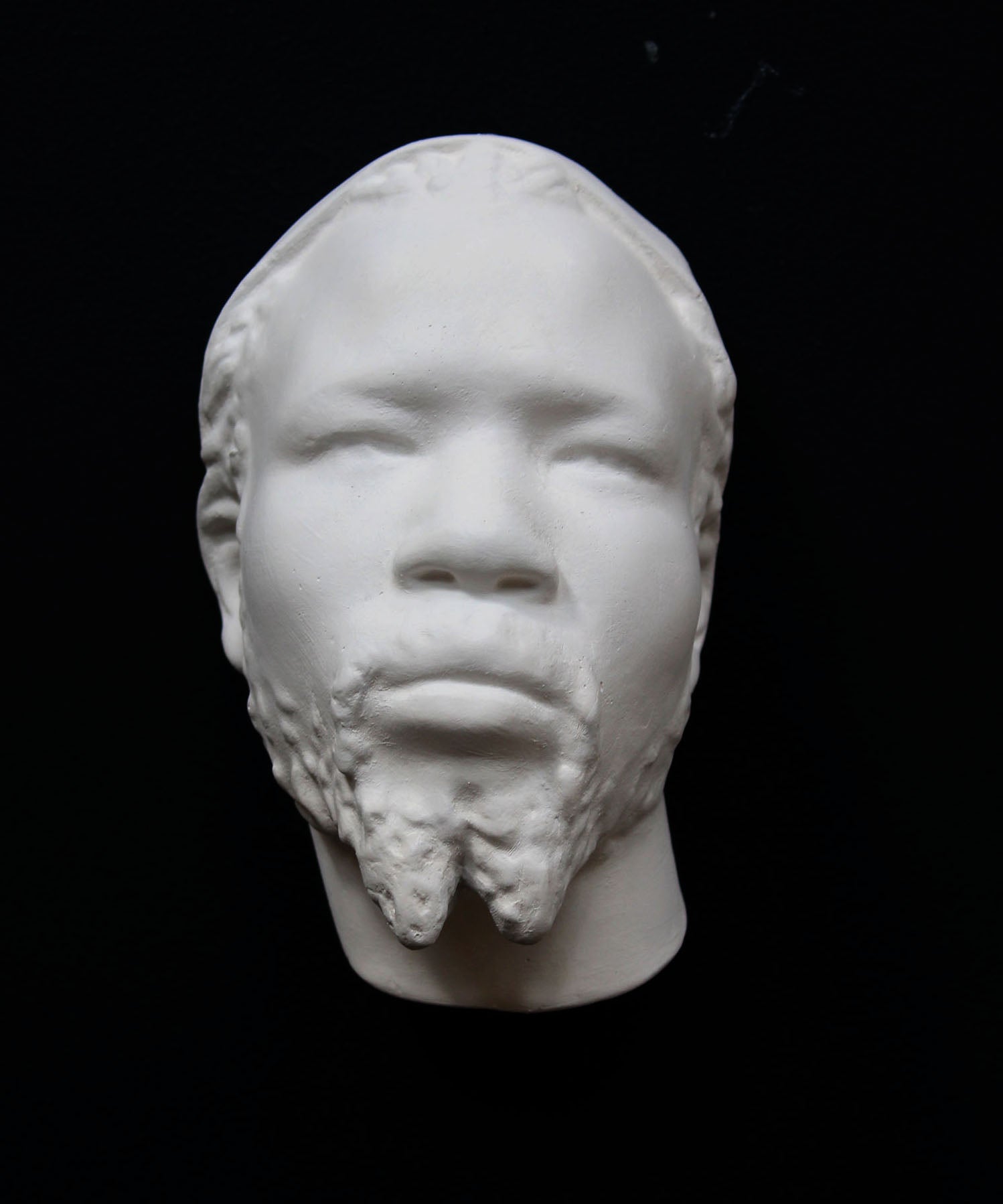 Photo of a sculpture of a Nubian head on a black background
