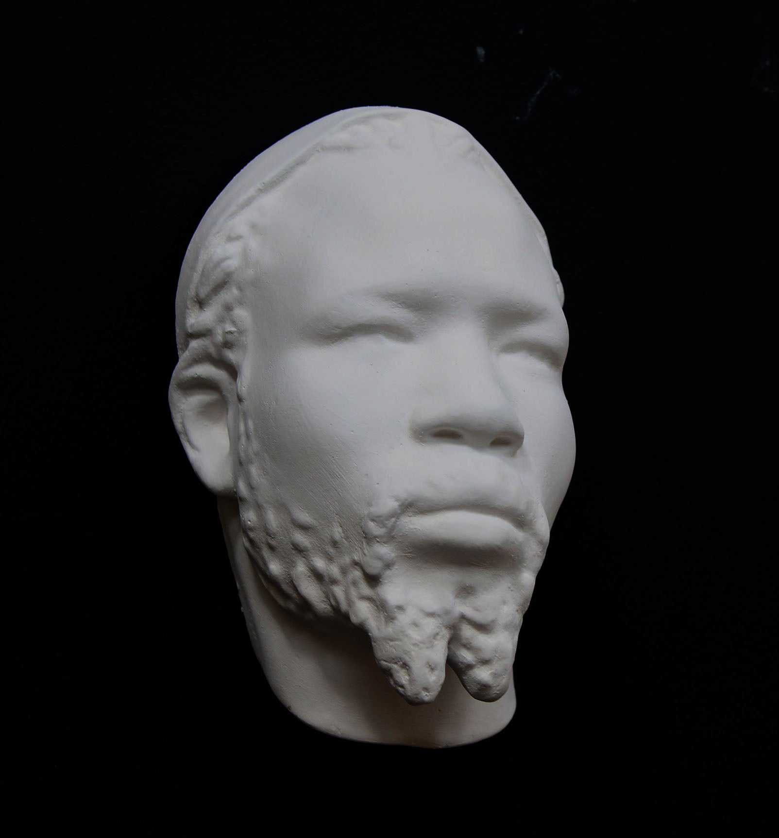 Photo of a sculpture of a Nubian head on a black background
