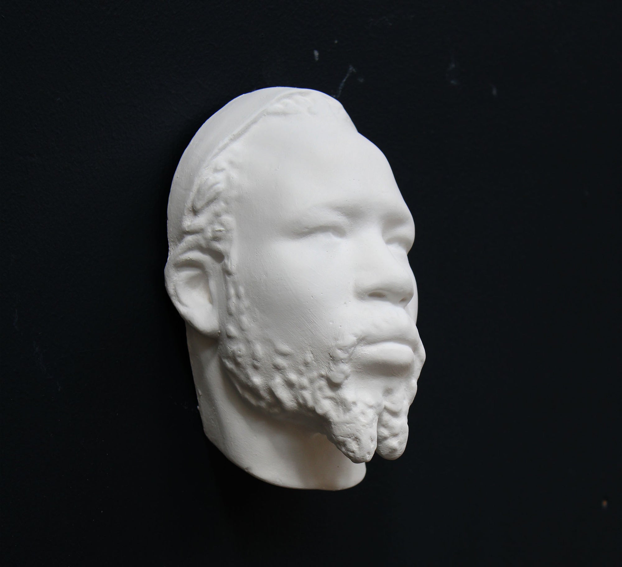 Photo of a sculpture of a Nubian head on a black background