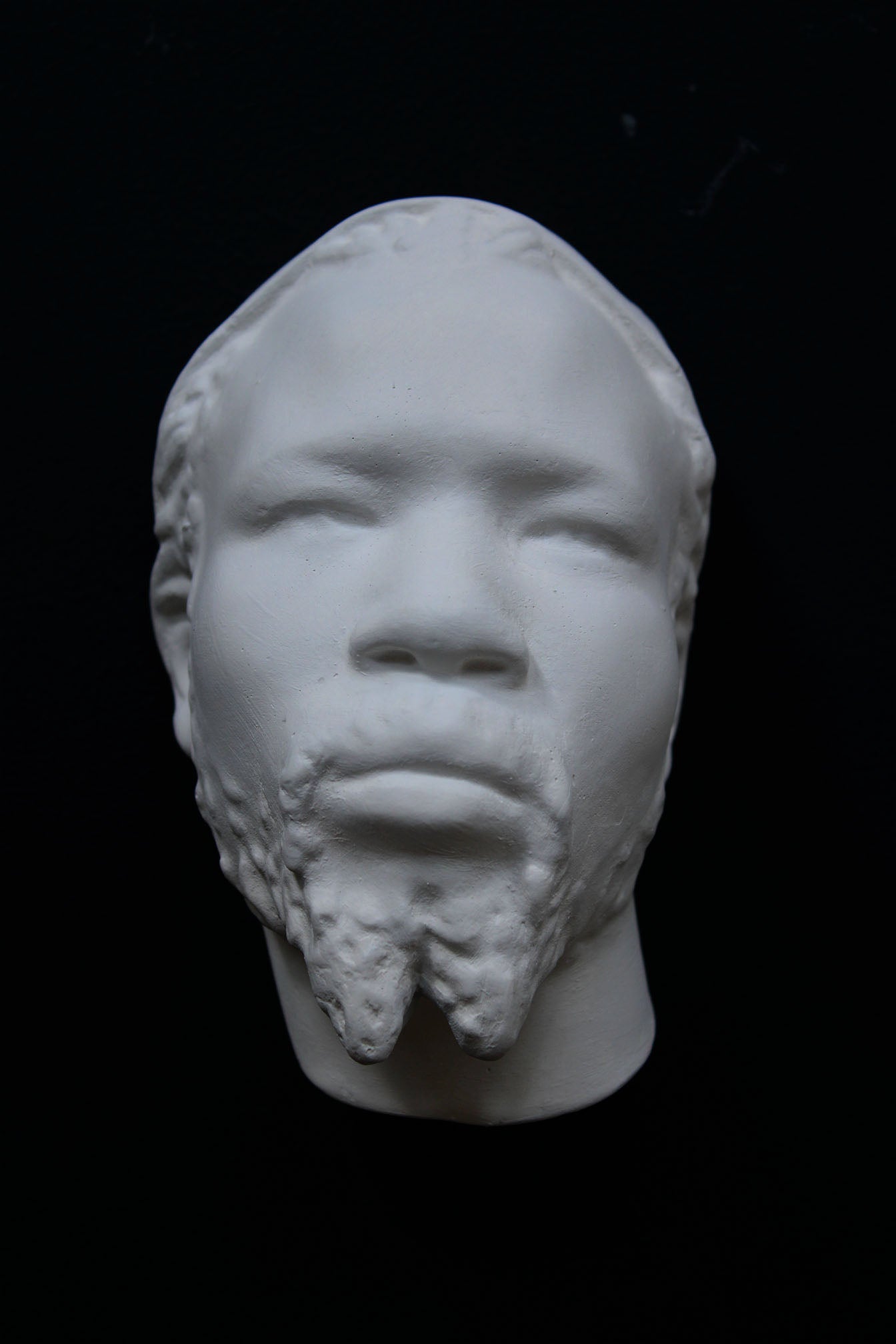 Photo of a sculpture of a Nubian head on a black background