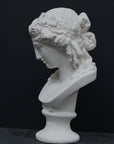 photo of plaster cast of sculpture bust of Ariadne or Bacchus with long, curly hair and head band on a black background