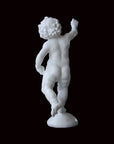 Photo of a sculpture of a cherub on a black background