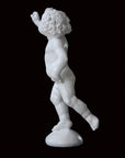 Photo of a sculpture of a cherub on a black background