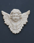 Photo of a  sculpture of a angel on a gray background