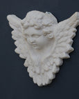 Photo of a  sculpture of a angel on a gray background
