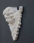 Photo of a  sculpture of a angel on a gray background