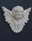 Photo of a  sculpture of a angel on a gray background