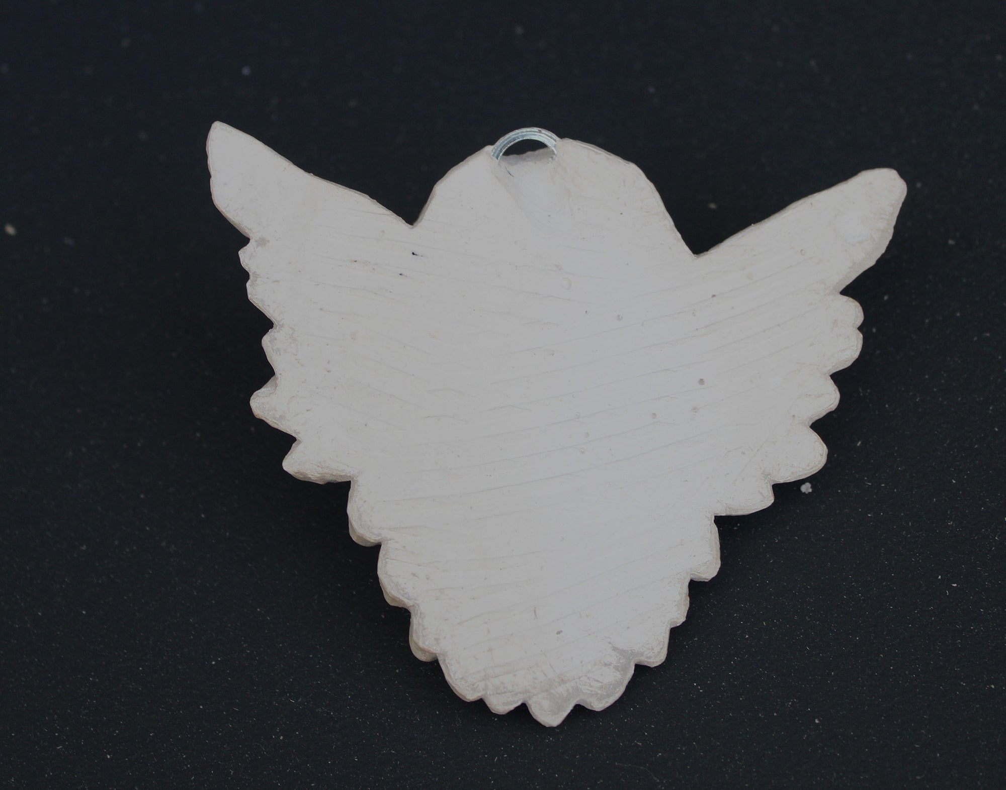 Photo of a  sculpture of a angel on a gray background