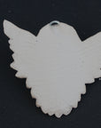 Photo of a  sculpture of a angel on a gray background