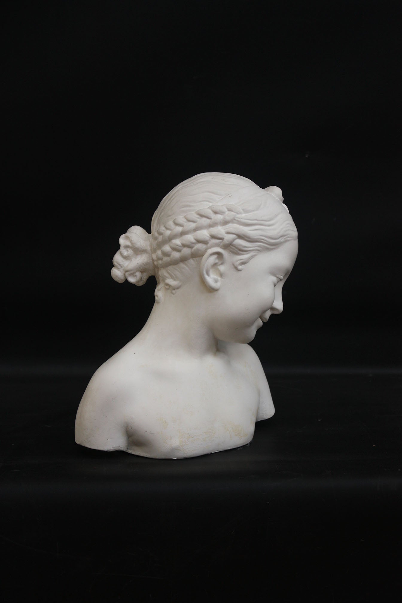 A photo of a sculpture of a Florentine girl on a black background  