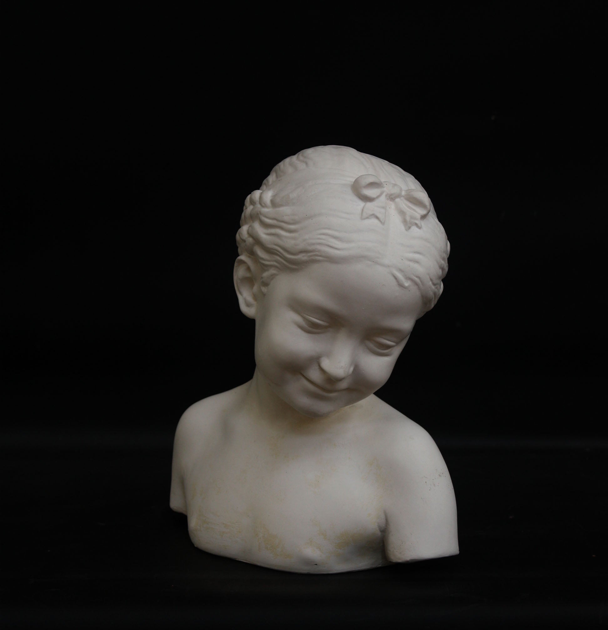 A photo of a sculpture of a Florentine girl on a black background  