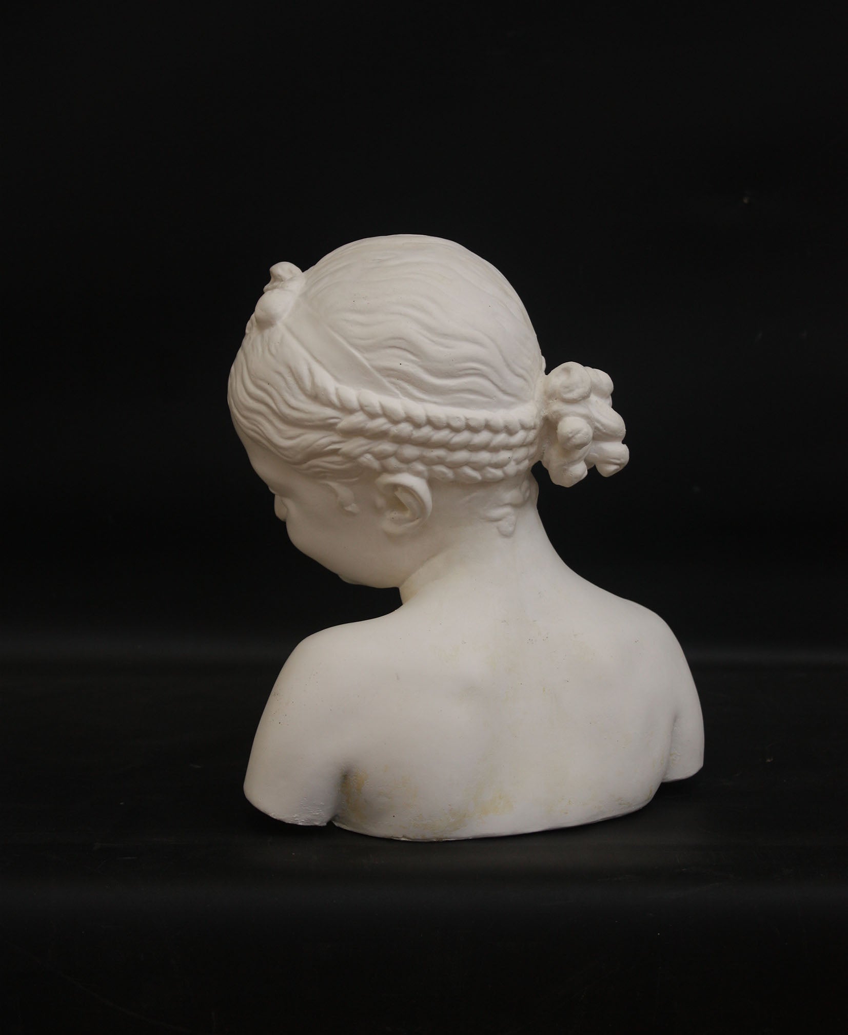A photo of a sculpture of a Florentine girl on a black background  