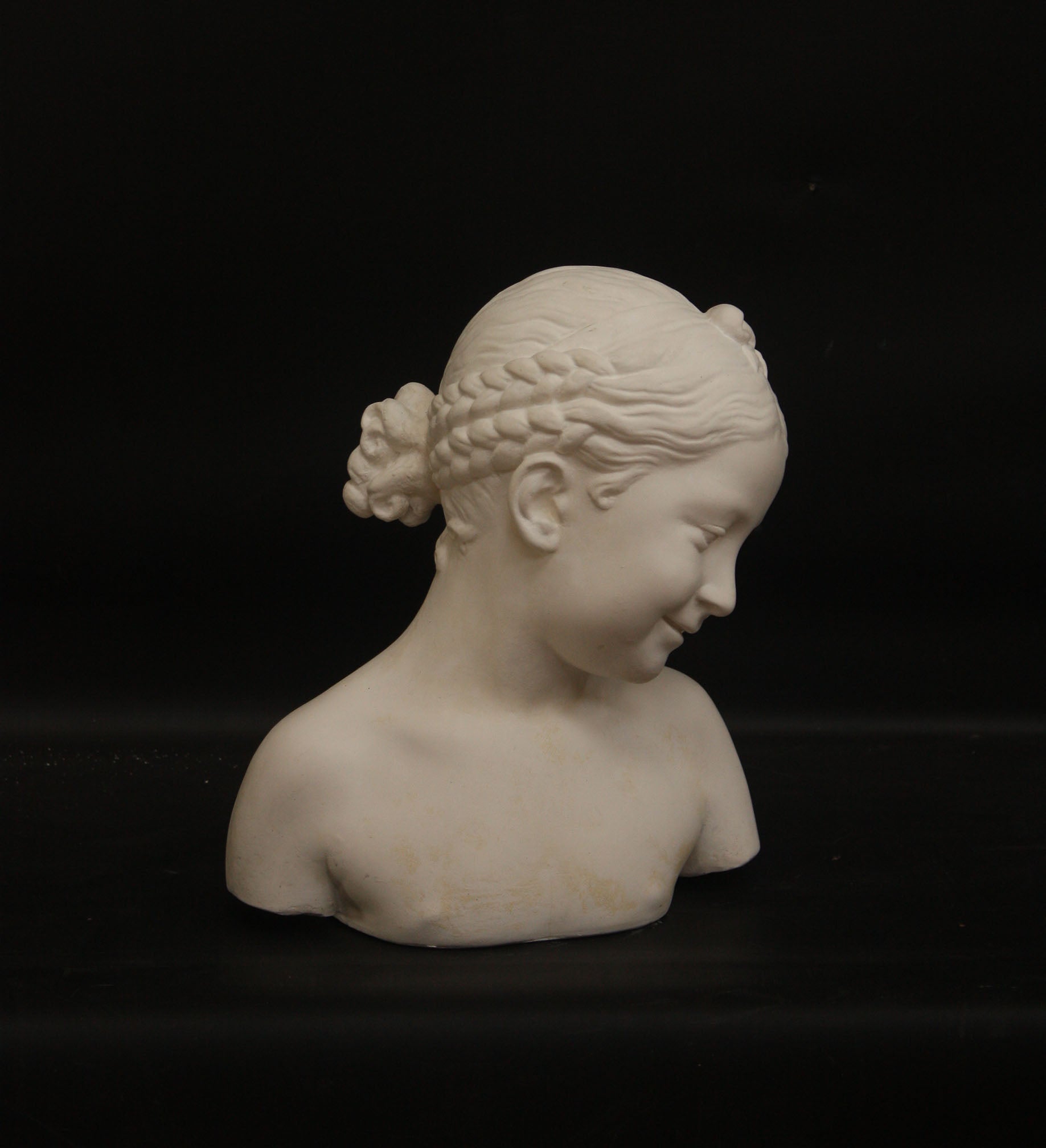A photo of a sculpture of a Florentine girl on a black background  