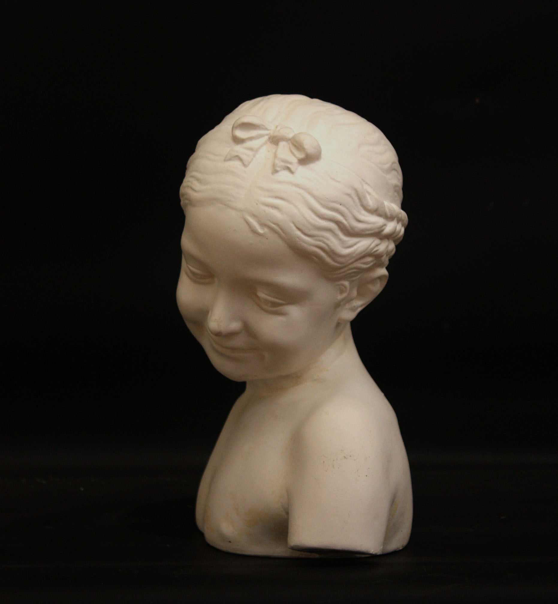 A photo of a sculpture of a Florentine girl on a black background  
