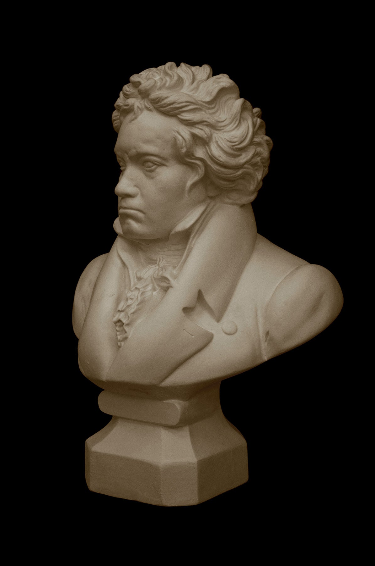 image of a plaster statue of a bust of Beethoven on a black background