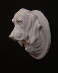 photo of a sculpture of a dog head on a black background 