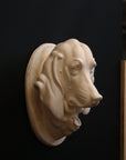 photo of a sculpture of a dog head on a black background 