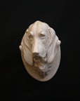 photo of a sculpture of a dog head on a black background 